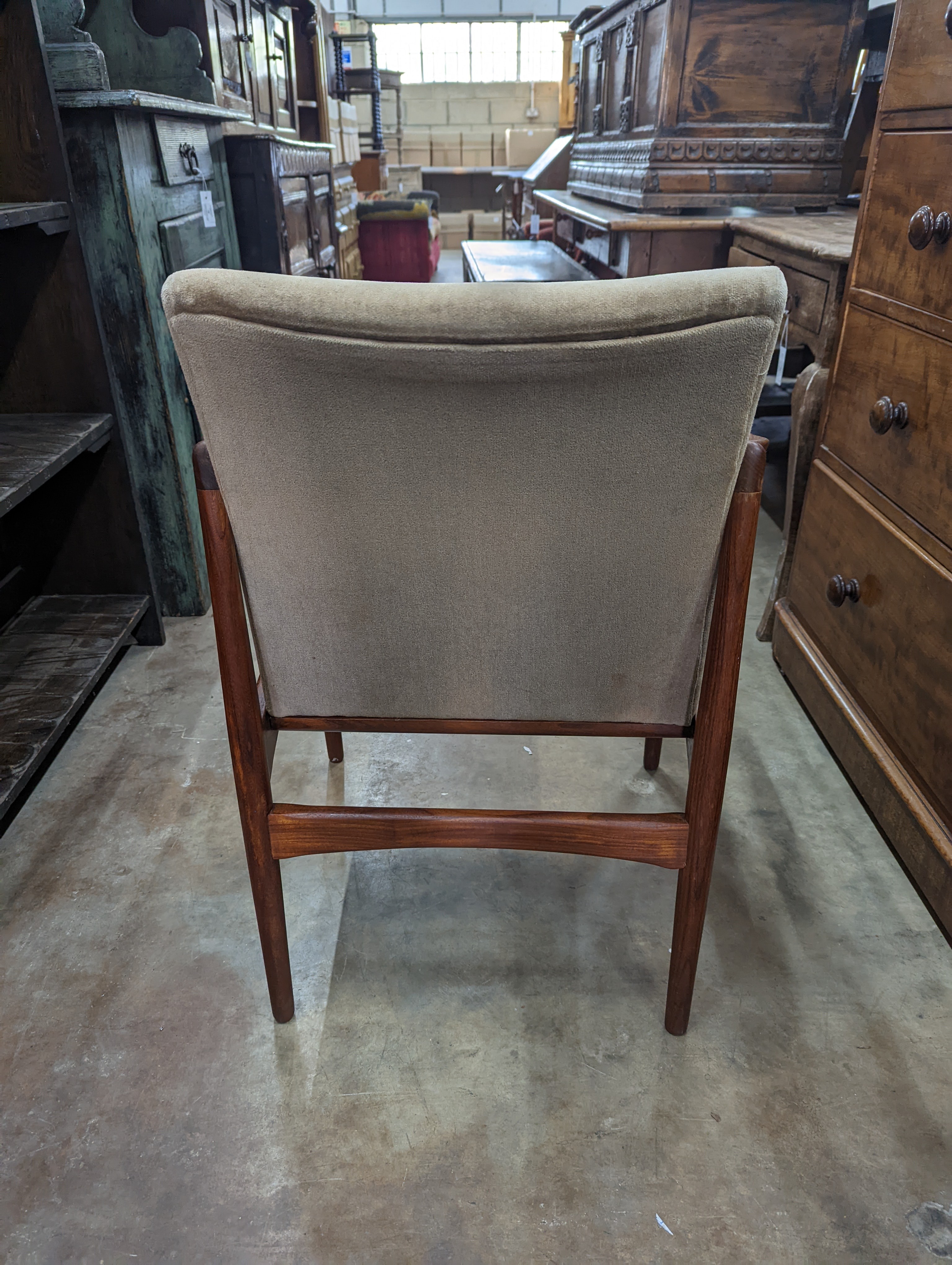 A pair of mid century teak upholstered elbow chairs, width 54cm, depth 63cm, height 84cm